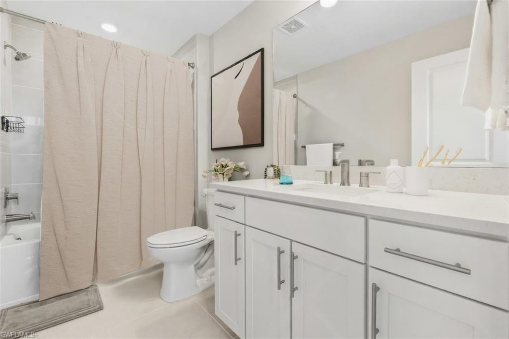 20250 Napa Loop Estero, FL 33928 - Photo 16 of 33 a bathroom with a toilet sink and mirror