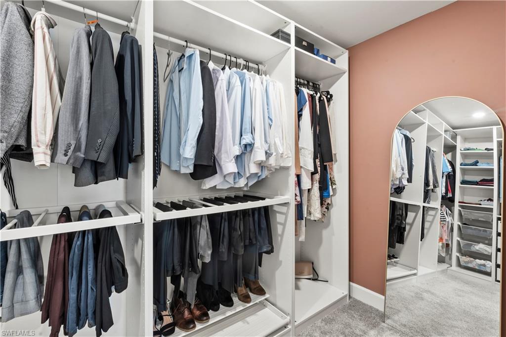 20250 Napa Loop Estero, FL 33928 - Photo 23 of 33 a view of walk in closet with clothes and shoes
