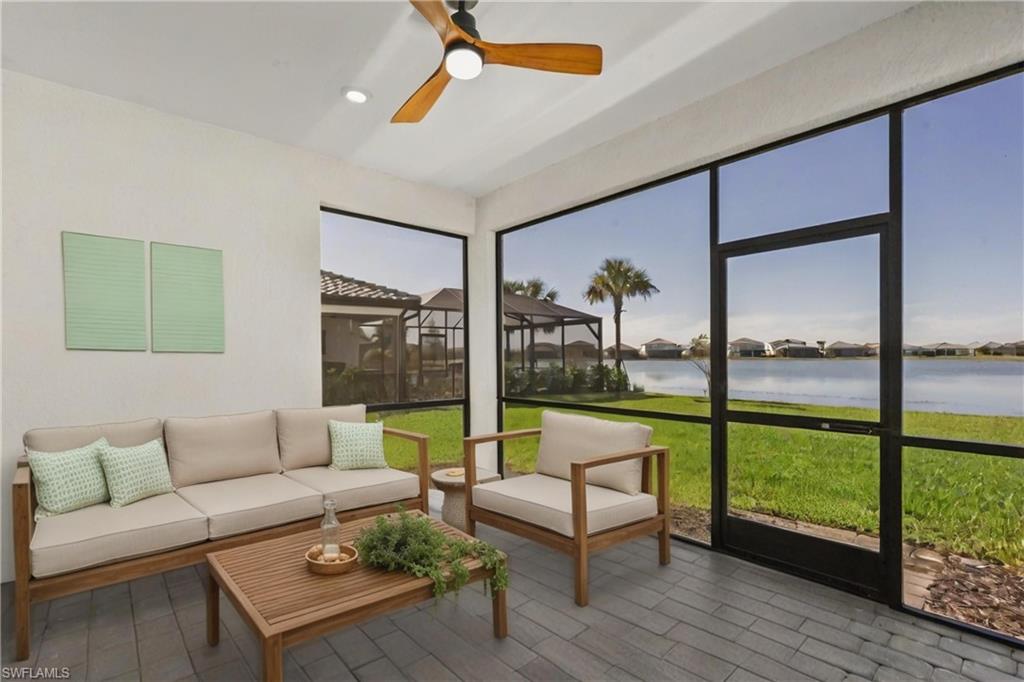 20250 Napa Loop Estero, FL 33928 - Photo 24 of 33 a living room with couch and a floor to ceiling window