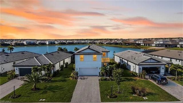 a aerial view of a house with a garden and lake view