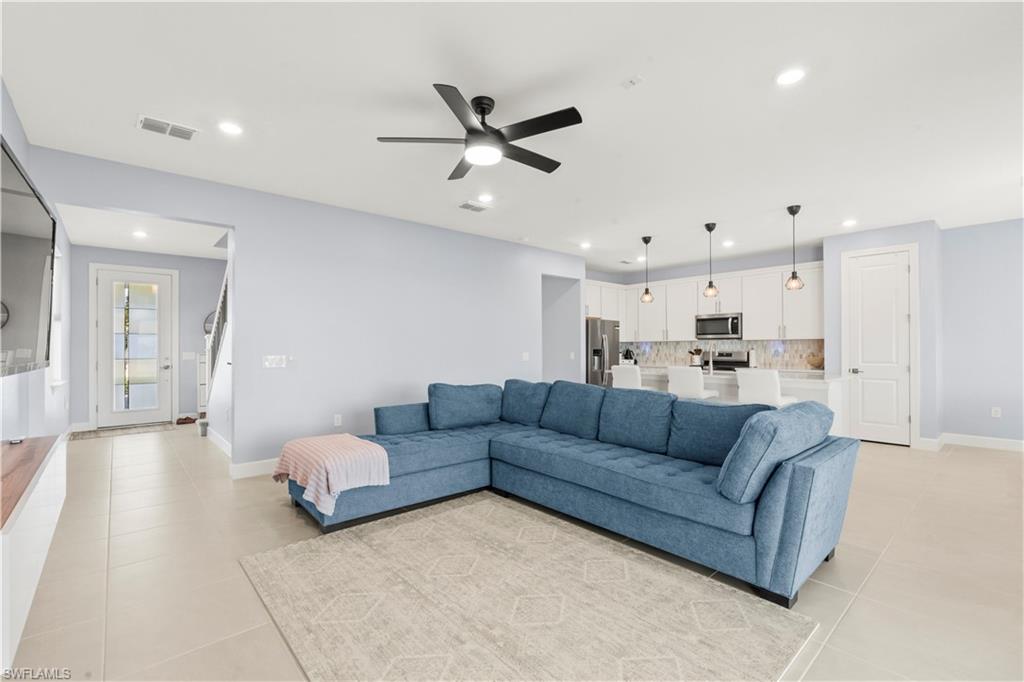 20250 Napa Loop Estero, FL 33928 - Photo 4 of 33 a living room with furniture and kitchen view