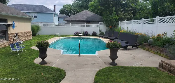 a view of a patio with table and chairs under an umbrella