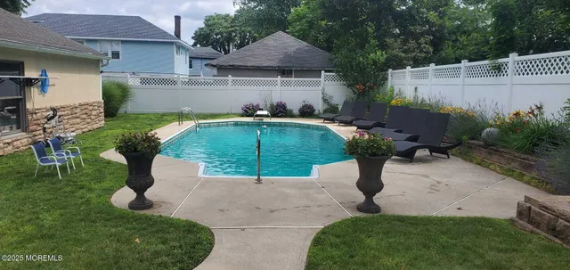 a view of a patio with table and chairs under an umbrella