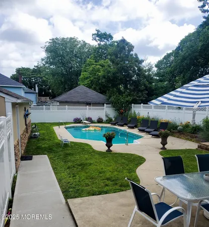 a bathroom with a granite countertop sink a mirror and shower