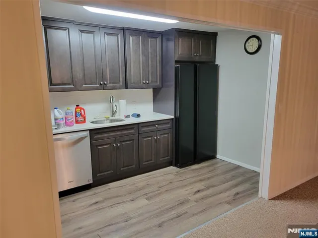 a kitchen with a refrigerator and cabinets