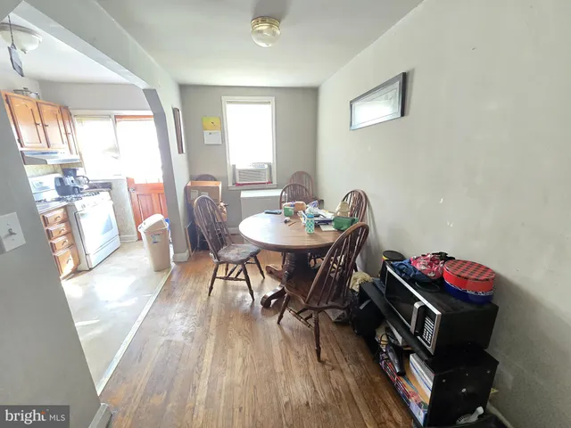 a dining room with furniture and wooden floor