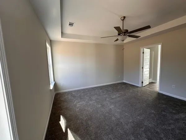 a view of a big room with a ceiling fan