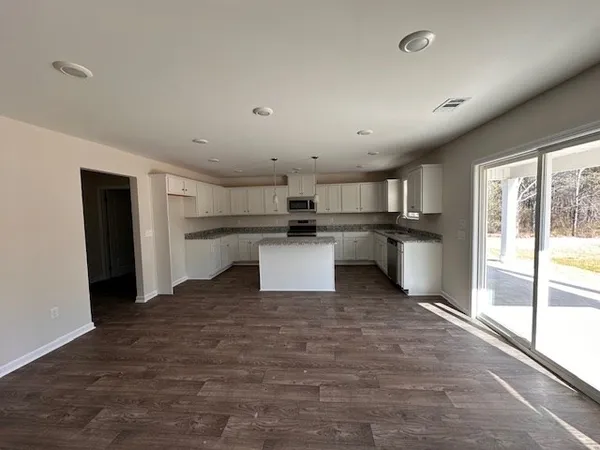 a kitchen with stainless steel appliances granite countertop a refrigerator and a stove top oven