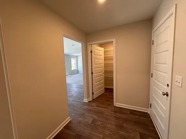 an empty room with wooden floor and cabinet