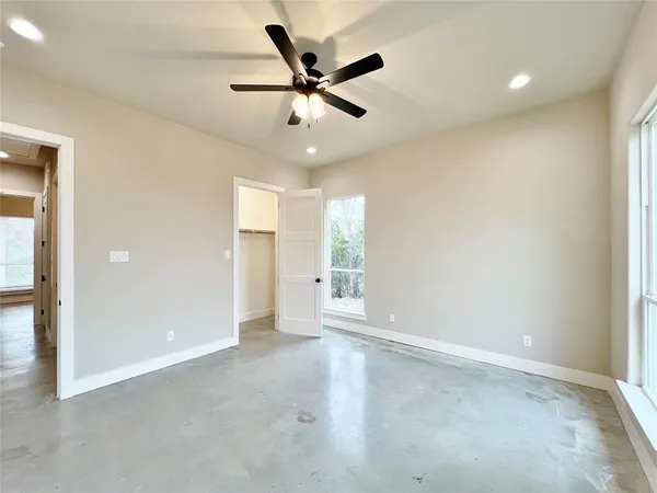 wooden floor in an empty room and a ceiling fan