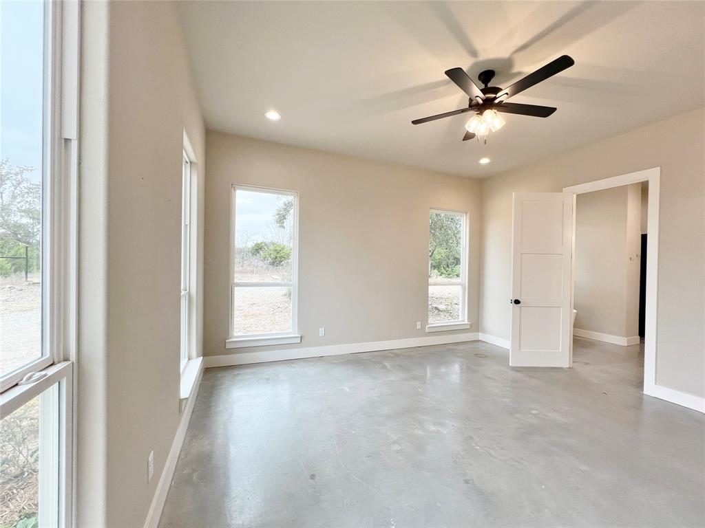 1141 Veal Station Road Springtown, TX 76082 - Photo 18 of 24 a view of an empty room with a window
