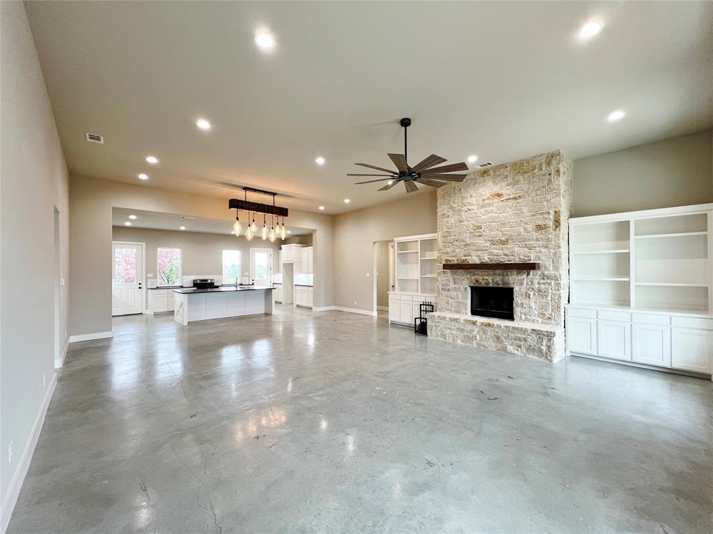 1141 Veal Station Road Springtown, TX 76082 - Photo 4 of 24 a view of empty room with wooden floor and fireplace