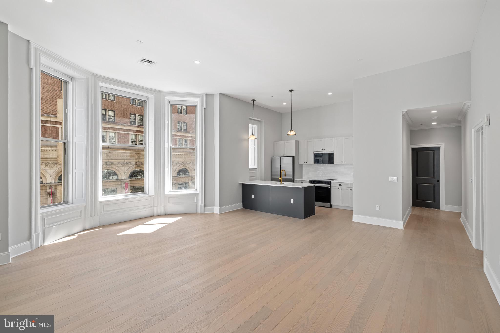 200 South Broad Street, Unit 906 Philadelphia, PA 19102 - Photo 14 of 49 a view of an empty room with a kitchen