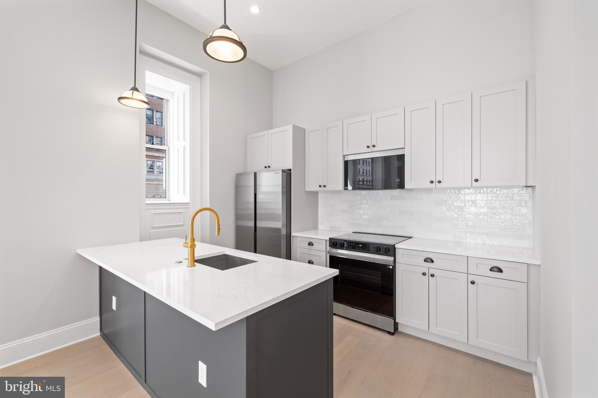 200 South Broad Street, Unit 906 Philadelphia, PA 19102 - Photo 15 of 49 a kitchen with a sink appliances and cabinets