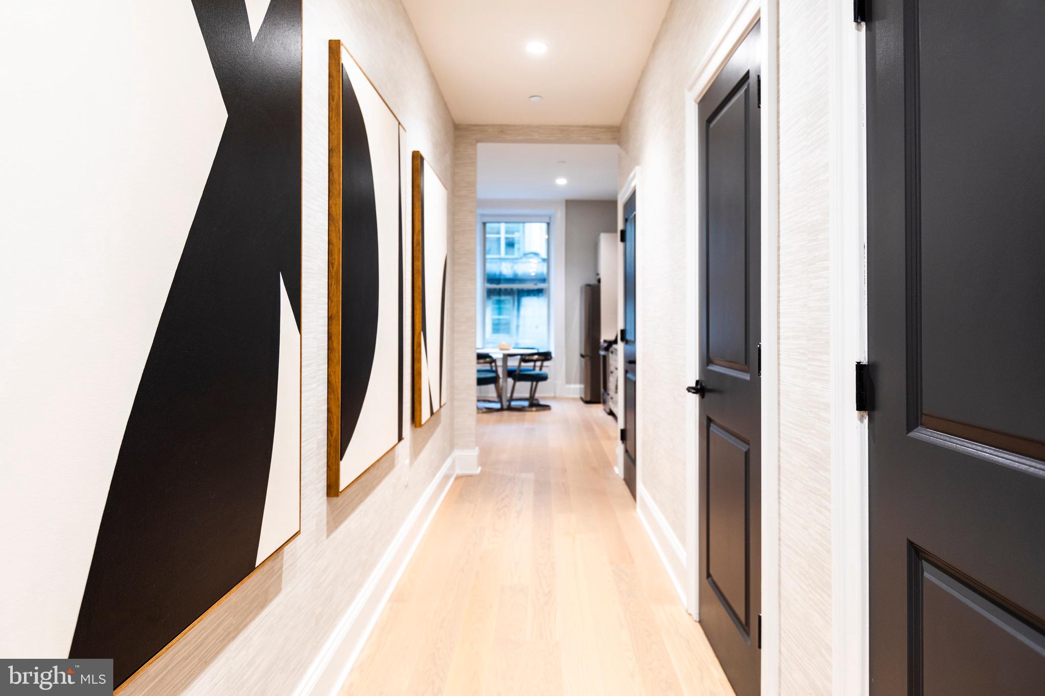 200 South Broad Street, Unit 906 Philadelphia, PA 19102 - Photo 4 of 49 a view of a hallway with wooden floor and furniture