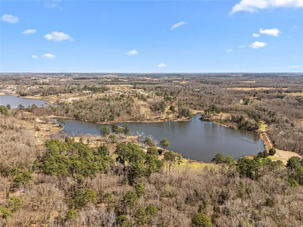 an aerial view of a house with a lake view