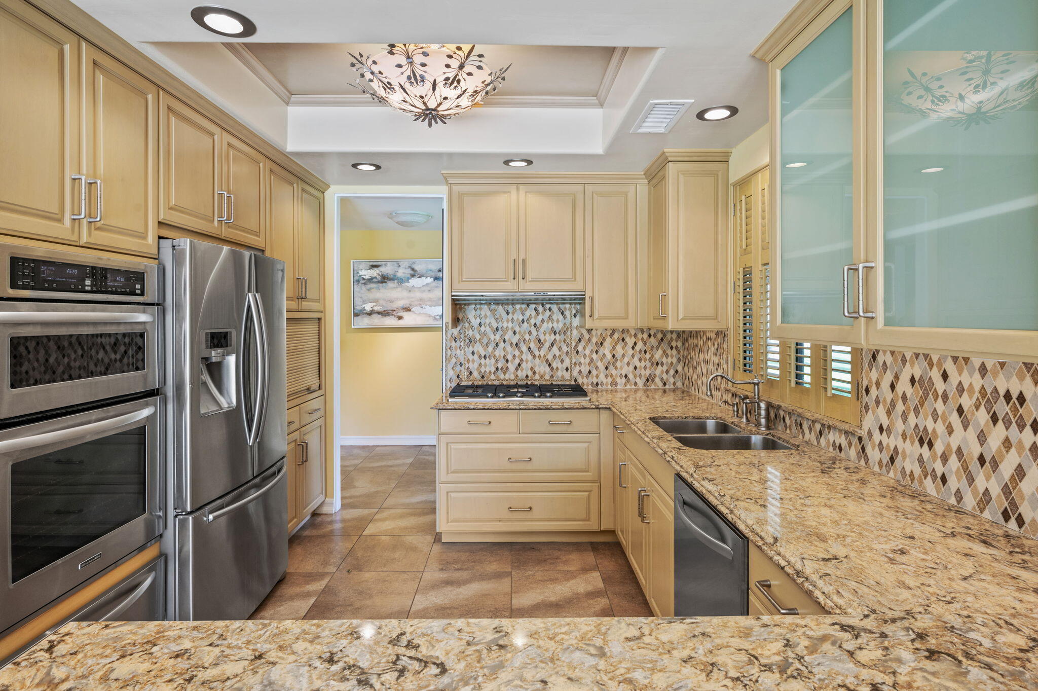 77675 Seminole Road Indian Wells, CA 92210 - Photo 11 of 40 a kitchen with stainless steel appliances a stove a sink and a refrigerator