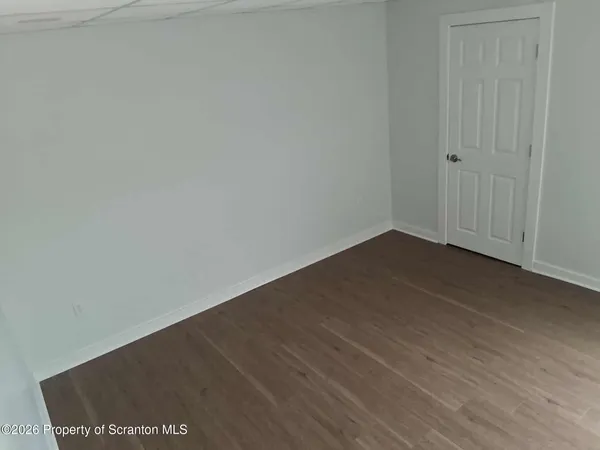 an empty room with wooden floor