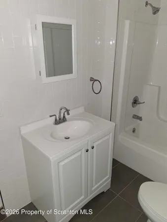 a bathroom with a sink a toilet and bathtub