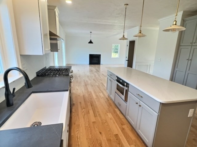 430 Mulpus Road Lunenburg, MA 01462 - Photo 2 of 27 a kitchen with stainless steel appliances a stove a sink a refrigerator and a wooden floor