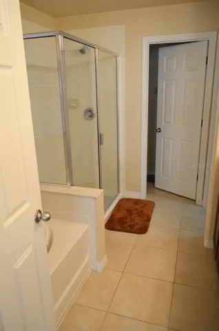 a bedroom with a bed and a mirror