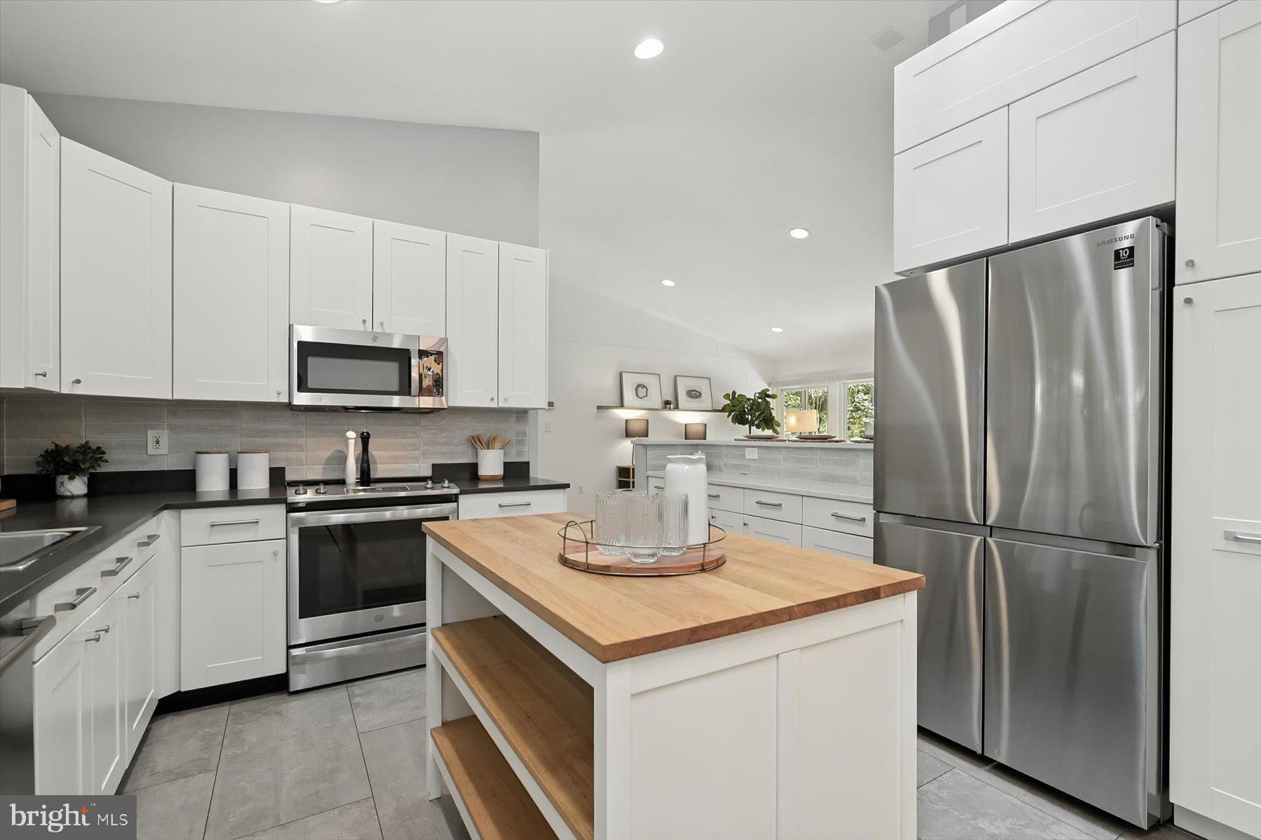 8216 Fenway Road Bethesda, MD 20817 - Photo 12 of 65 a kitchen with a sink a refrigerator a microwave and cabinets