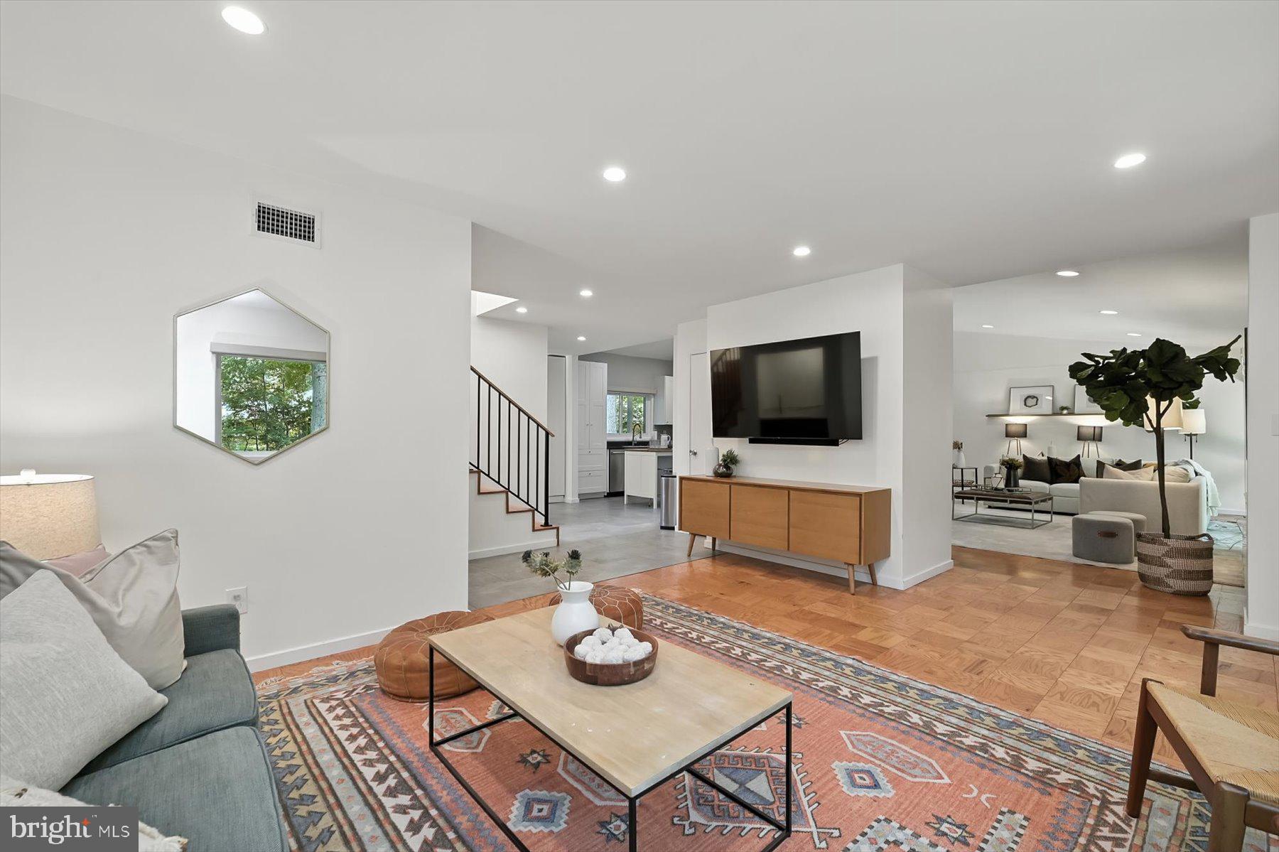 8216 Fenway Road Bethesda, MD 20817 - Photo 16 of 65 a living room with furniture and a flat screen tv