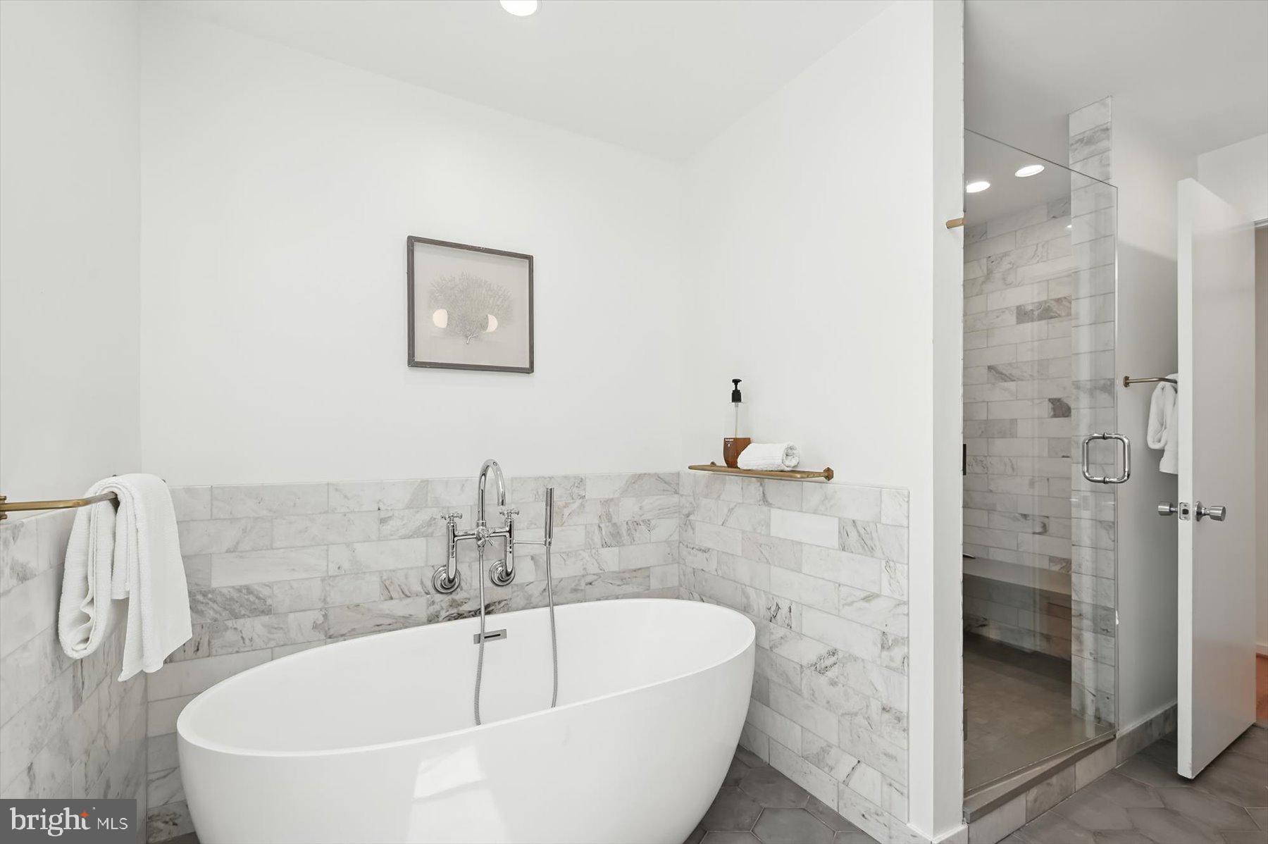 8216 Fenway Road Bethesda, MD 20817 - Photo 24 of 65 a bathroom with a tub and shower