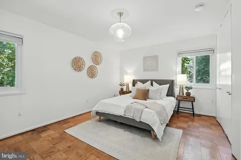 a bedroom with furniture and a chandelier