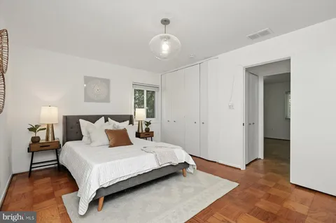 a bedroom with a bed and a large mirror