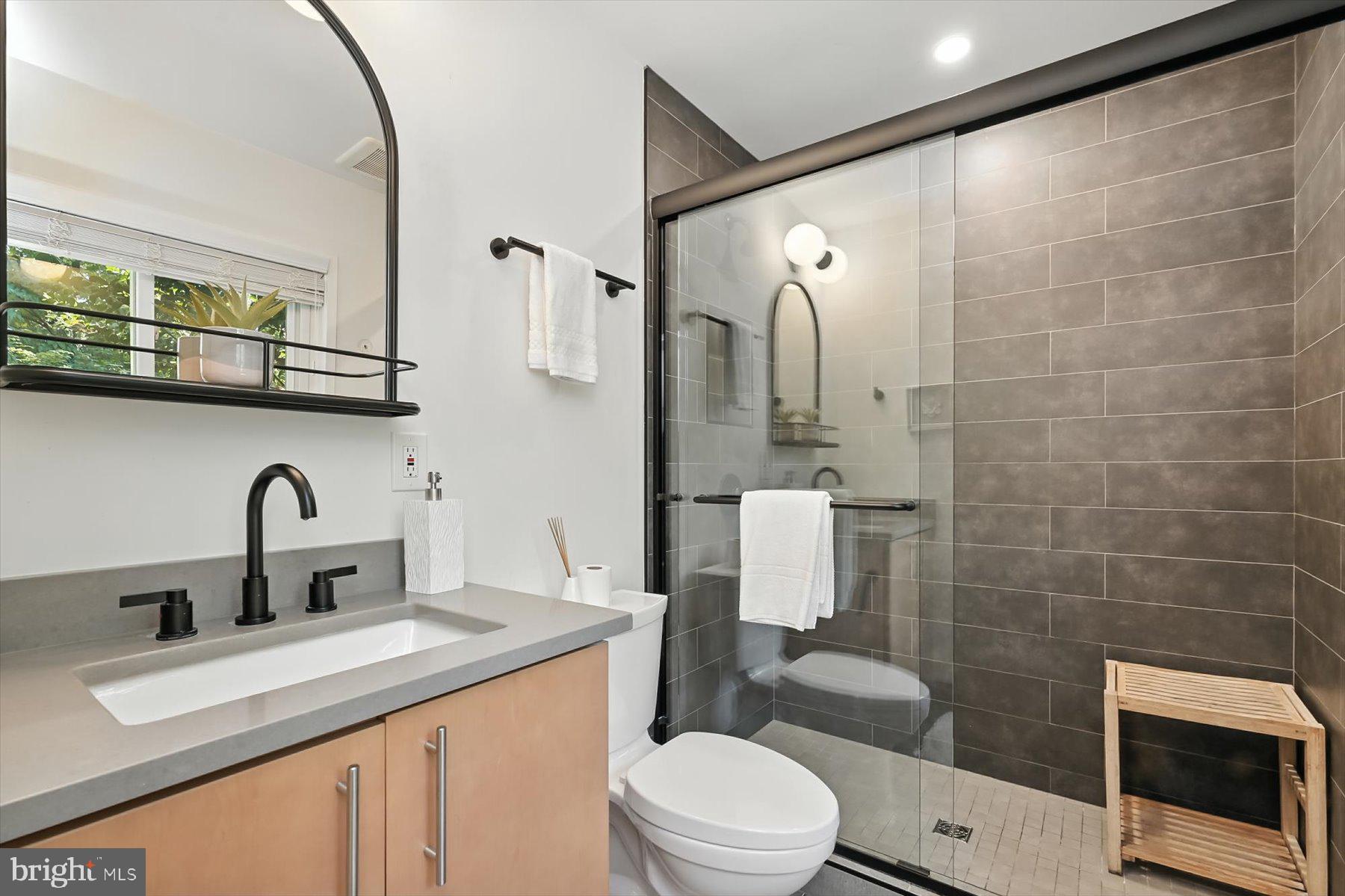 8216 Fenway Road Bethesda, MD 20817 - Photo 37 of 65 a bathroom with a sink a toilet and shower