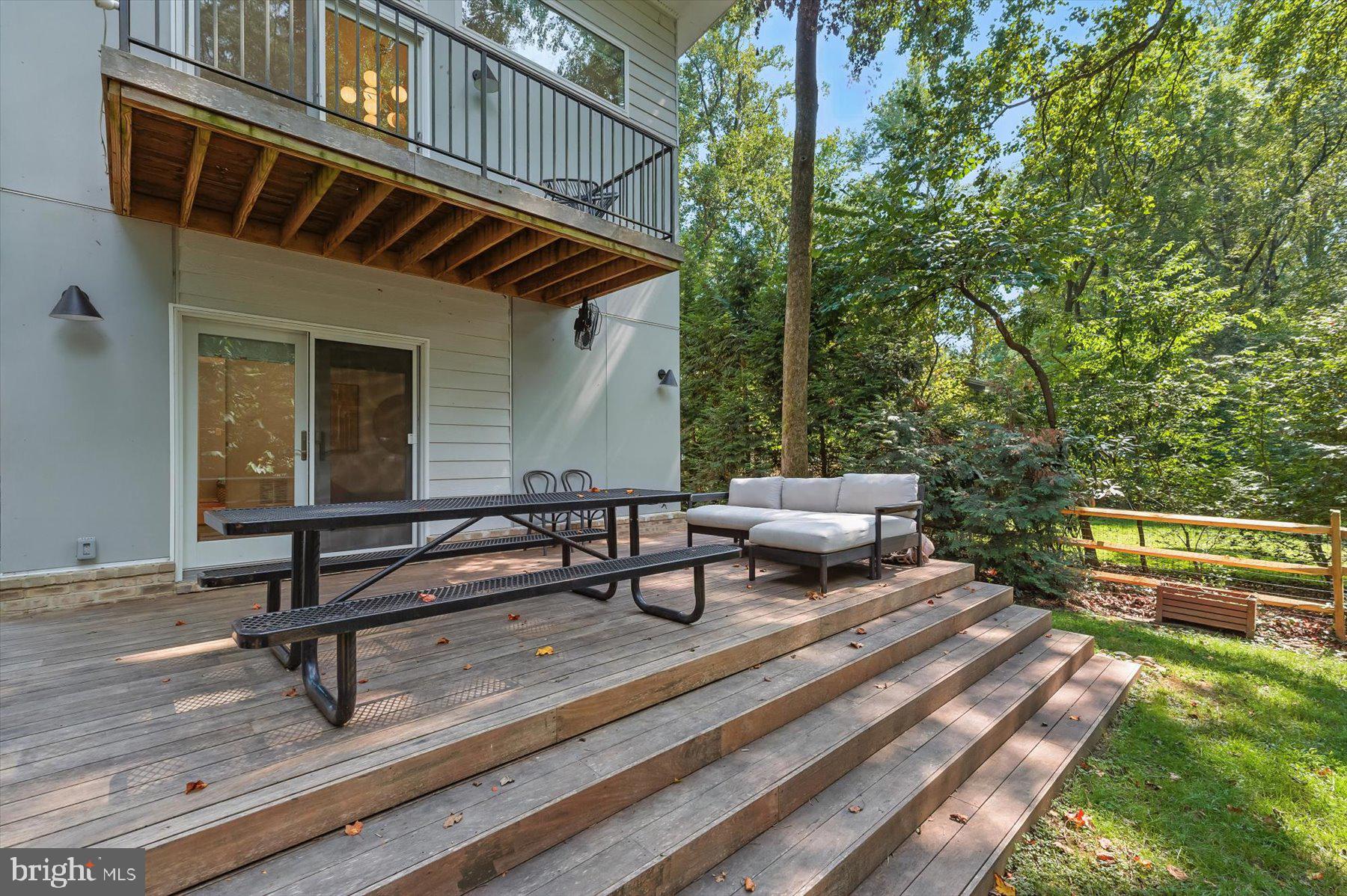 8216 Fenway Road Bethesda, MD 20817 - Photo 49 of 65 a view of a patio with table and chairs with wooden floor and fence