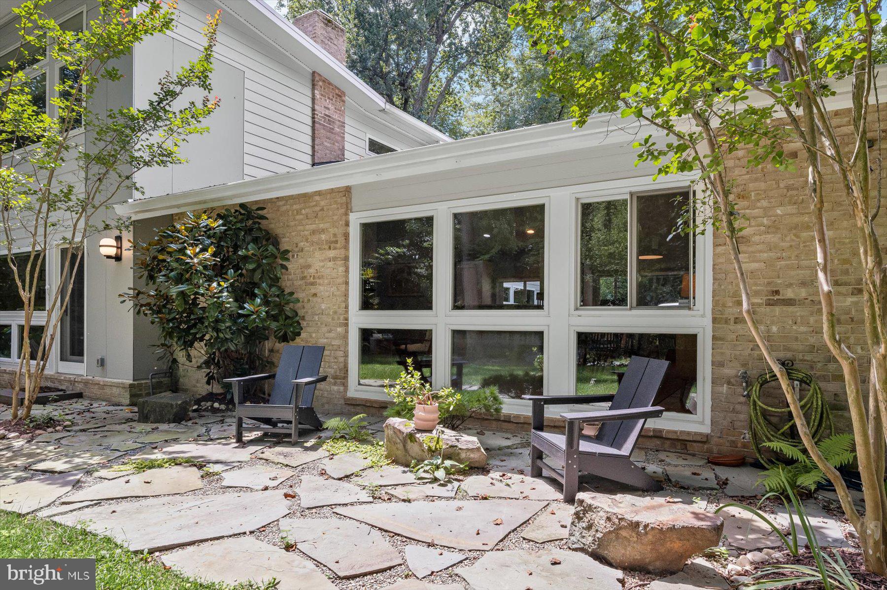 8216 Fenway Road Bethesda, MD 20817 - Photo 52 of 65 a view of a house with backyard sitting area and porch
