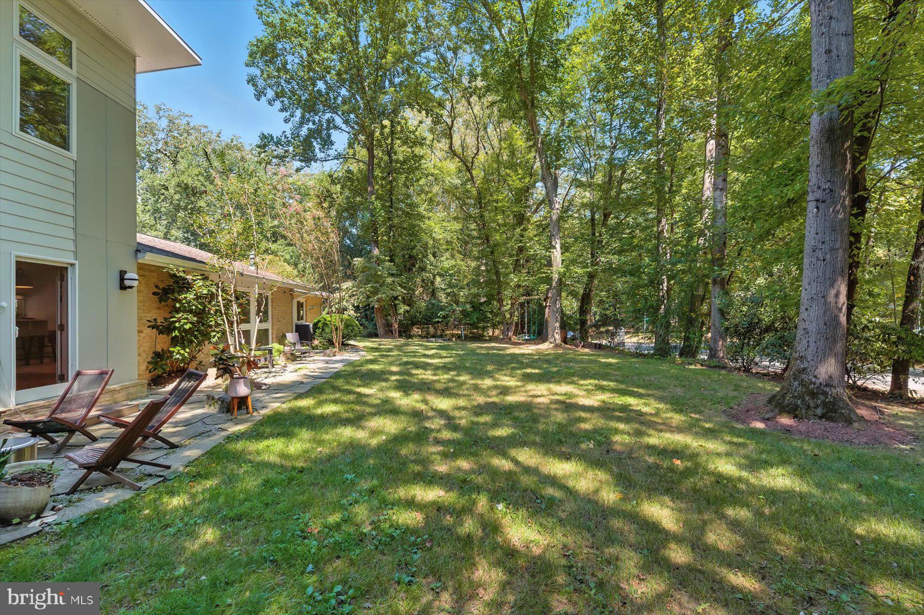 8216 Fenway Road Bethesda, MD 20817 - Photo 56 of 65 a view of backyard with table and chairs and wooden fence