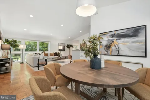 a dining room with furniture and wooden floor