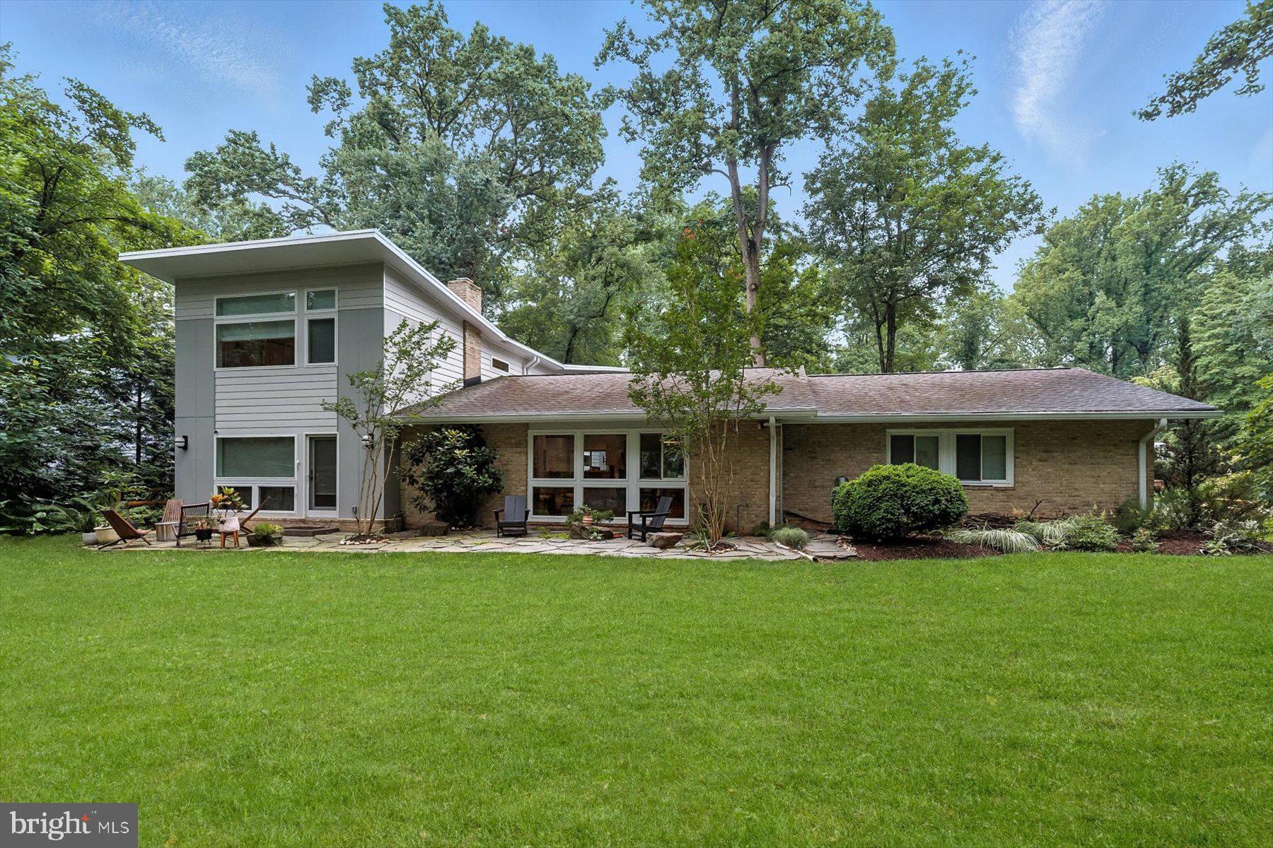 8216 Fenway Road Bethesda, MD 20817 - Photo 62 of 65 a front view of a house with a garden and trees