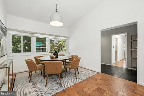 a dining room with furniture and window