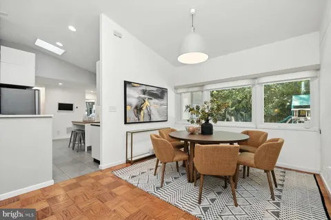 a kitchen with a sink a refrigerator a microwave and cabinets