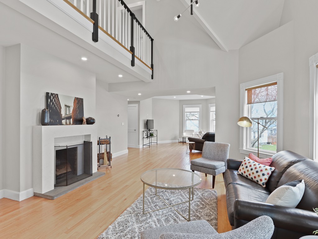 76-78 Page Road Newton, MA 02460 - Photo 9 of 42 a living room with furniture a fireplace and a large window