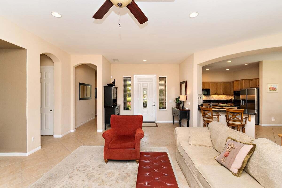 81086 Barrel Cactus Road La Quinta, CA 92253 - Photo 17 of 36 a living room with furniture kitchen view and a large window