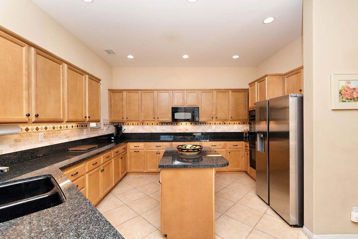 81086 Barrel Cactus Road La Quinta, CA 92253 - Photo 20 of 36 a kitchen with stainless steel appliances granite countertop a refrigerator and a stove