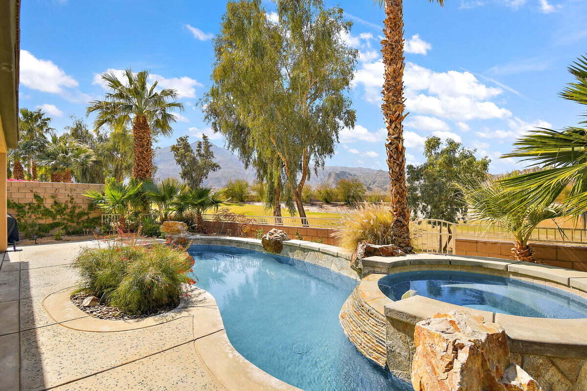81086 Barrel Cactus Road La Quinta, CA 92253 - Photo 2 of 36 a view of a swimming pool and lounge chair