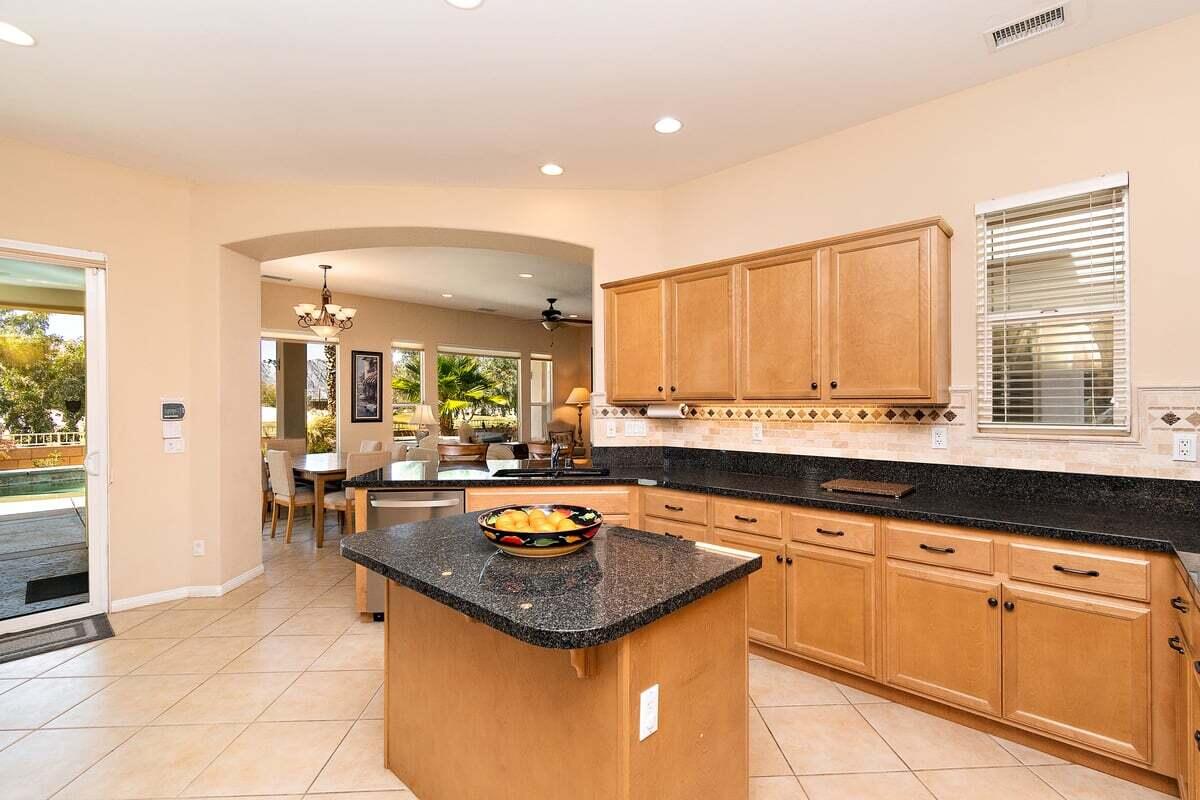 81086 Barrel Cactus Road La Quinta, CA 92253 - Photo 22 of 36 a kitchen with a sink and cabinets