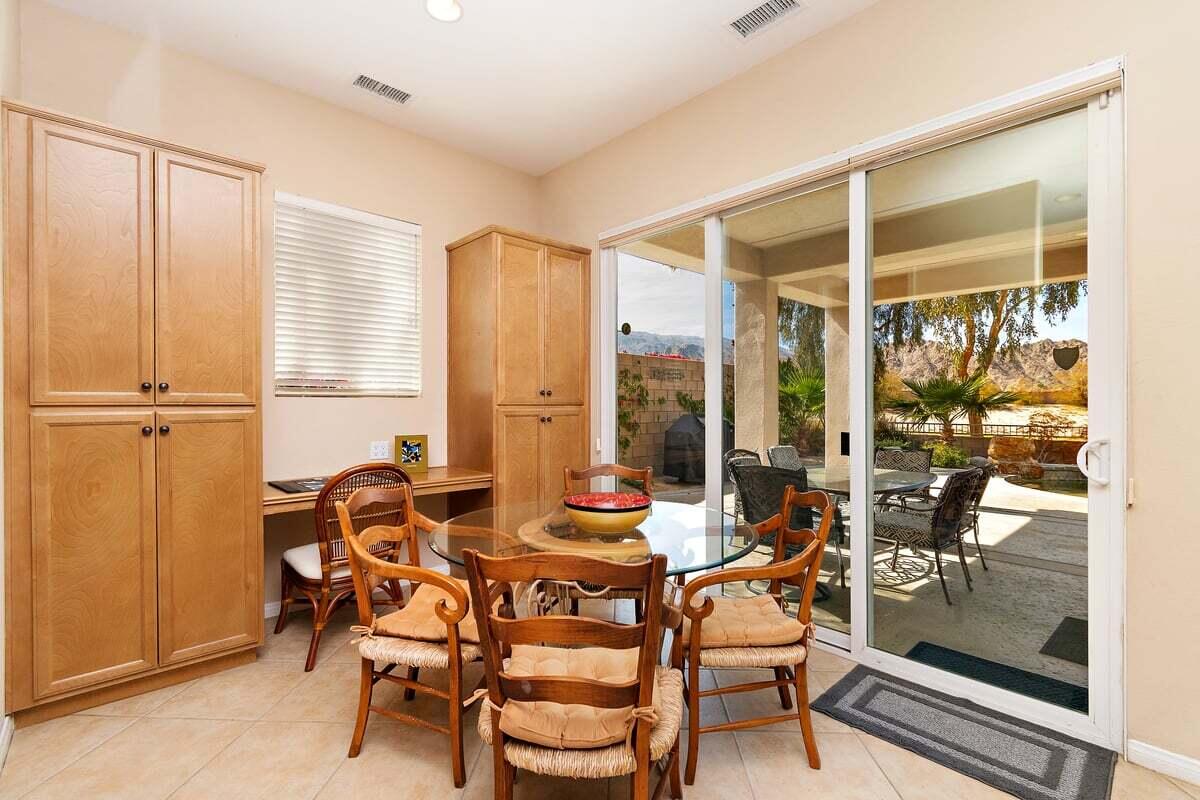 81086 Barrel Cactus Road La Quinta, CA 92253 - Photo 23 of 36 a dining room with furniture and a floor to ceiling window