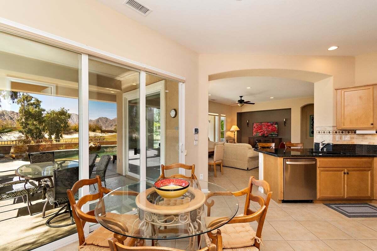 81086 Barrel Cactus Road La Quinta, CA 92253 - Photo 24 of 36 a dining room with furniture a window and a kitchen view