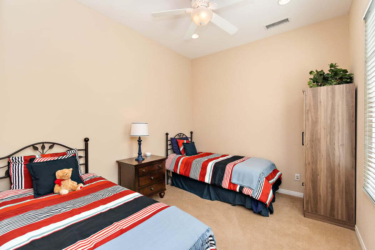 81086 Barrel Cactus Road La Quinta, CA 92253 - Photo 30 of 36 a bedroom with a bed and a lamp