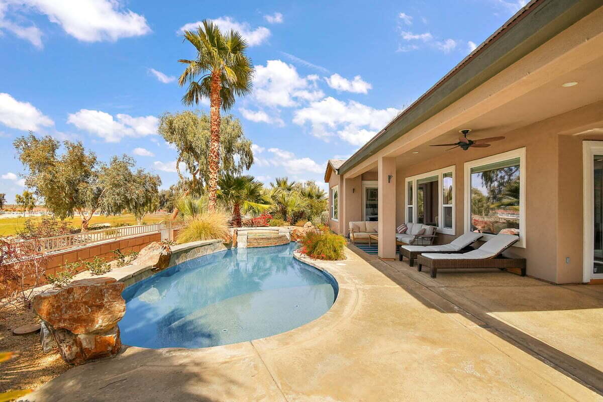 81086 Barrel Cactus Road La Quinta, CA 92253 - Photo 3 of 36 a view of a swimming pool with furniture
