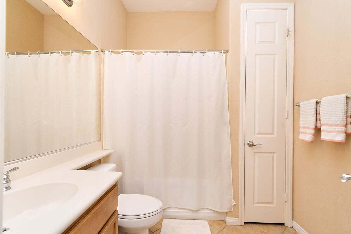 81086 Barrel Cactus Road La Quinta, CA 92253 - Photo 31 of 36 a white toilet sitting next to a shower curtain