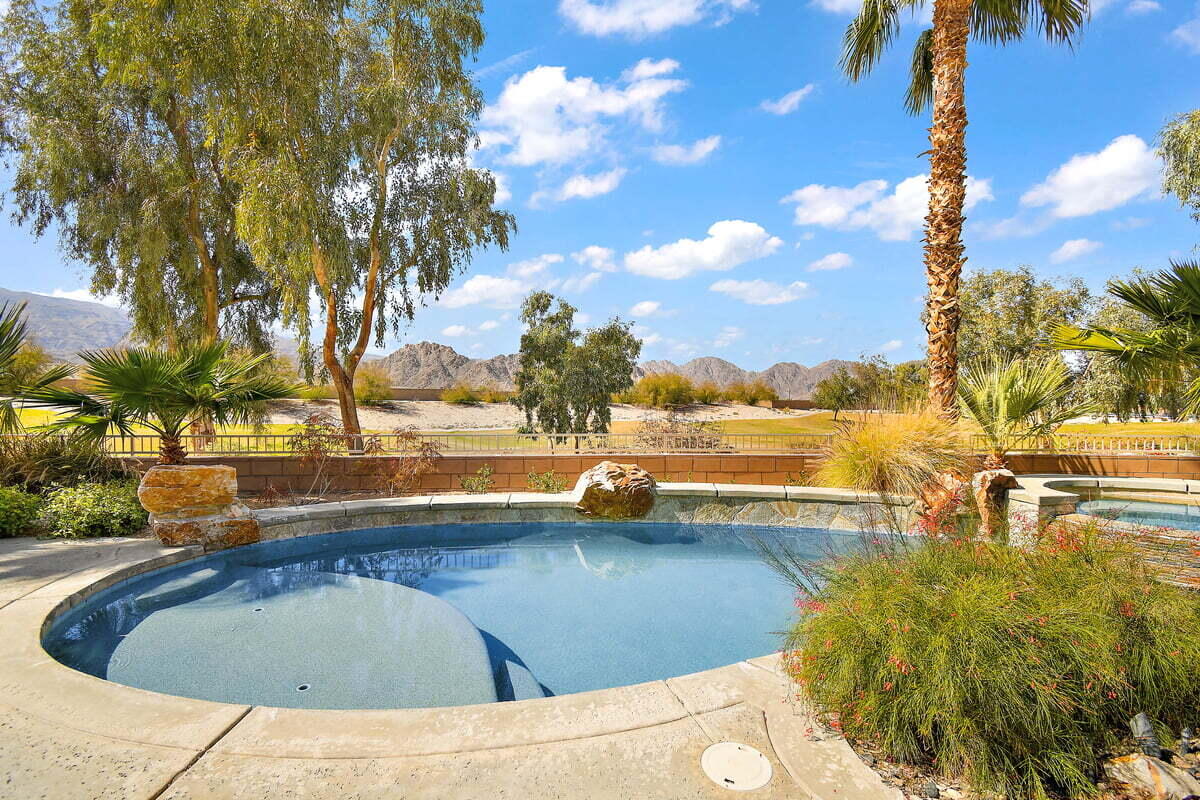 81086 Barrel Cactus Road La Quinta, CA 92253 - Photo 5 of 36 a view of a swimming pool with an outdoor seating and a yard