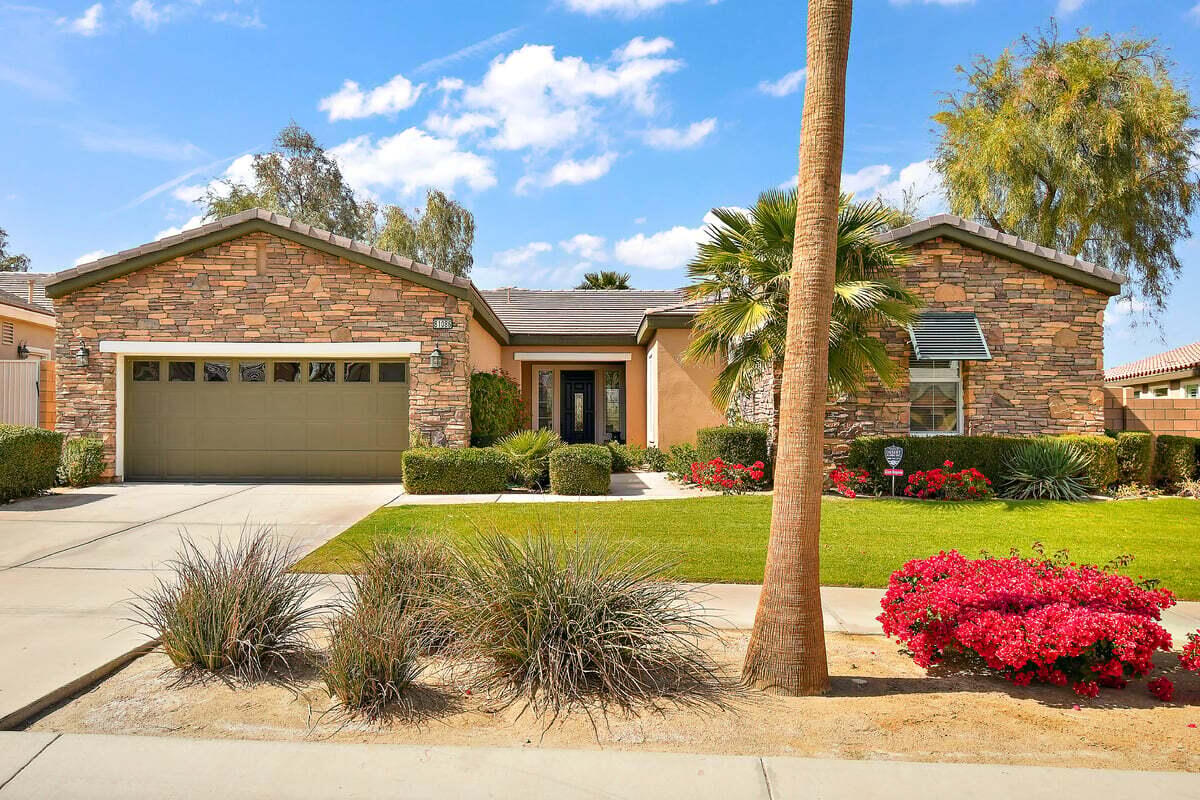 81086 Barrel Cactus Road La Quinta, CA 92253 - Photo 10 of 36 a front view of a house with a garden and yard